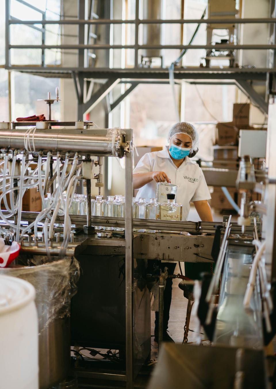 A technician working inside the bottling plant